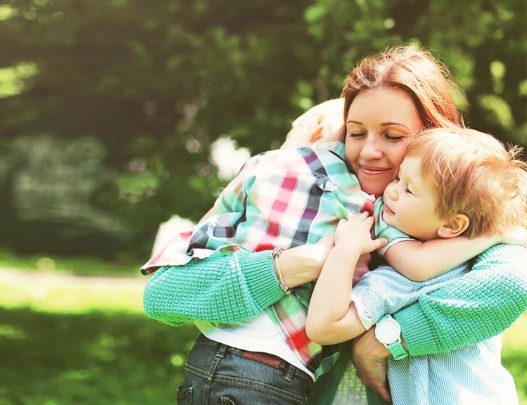 mom hugging children after chronic illness diagnosis