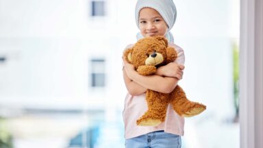 childhood leukemia patient with teddy bear