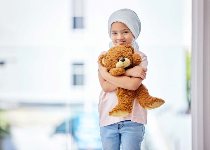 childhood leukemia patient with teddy bear