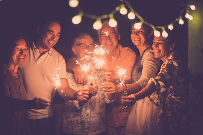 group celebrating with sparklers